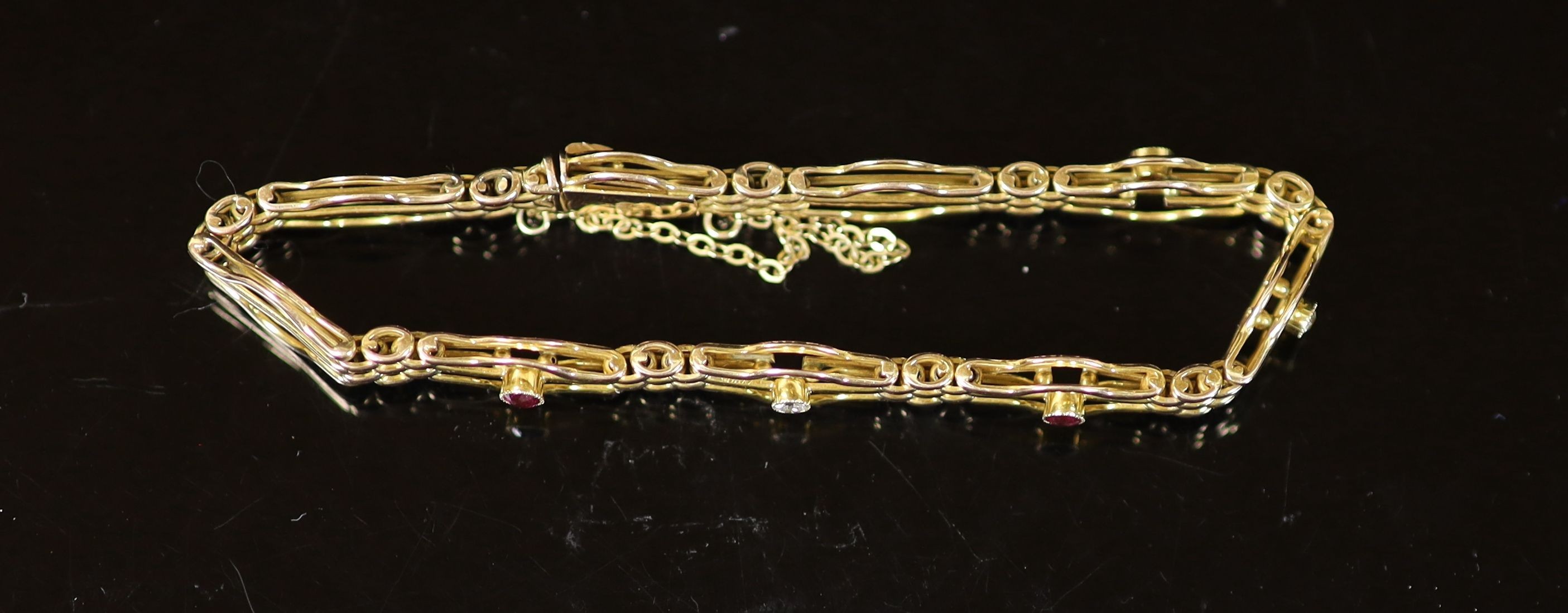 An Edwardian 15ct gold, three stone ruby and two stone diamond set fancy link bracelet